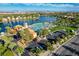 Beautiful aerial view of community lake with sandy beach, palms, and clubhouse at 3125 N Buffalo Dr # 1091, Las Vegas, NV 89128