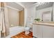 Well-lit bathroom features a bathtub, shower, single sink vanity, and wood-look floors at 3125 N Buffalo Dr # 1091, Las Vegas, NV 89128