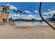 Sandy community beach featuring palm trees, umbrellas, and a lake at 3125 N Buffalo Dr # 1091, Las Vegas, NV 89128