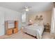 Inviting bedroom offers a ceiling fan, a cozy bed, and a view into the bathroom at 3125 N Buffalo Dr # 1091, Las Vegas, NV 89128