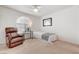 Comfortable bedroom featuring a chair, lots of light from the window, and neutral decor at 3125 N Buffalo Dr # 1091, Las Vegas, NV 89128