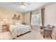 Bright bedroom with a ceiling fan, window, comfortable chair, and stylish decor at 3125 N Buffalo Dr # 1091, Las Vegas, NV 89128