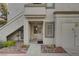 Charming condo entrance with a decorative white chair and rock landscaping at 3125 N Buffalo Dr # 1091, Las Vegas, NV 89128
