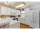 Bright kitchen featuring white cabinets, stainless steel refrigerator, and tile countertops at 3125 N Buffalo Dr # 1091, Las Vegas, NV 89128