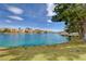 Picturesque lake view showcasing waterfront homes, lush greenery, and vibrant blue water at 3125 N Buffalo Dr # 1091, Las Vegas, NV 89128