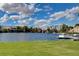 Scenic lake view with lush green lawn, private docks, and waterfront homes at 3125 N Buffalo Dr # 1091, Las Vegas, NV 89128