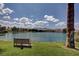 Lake view featuring a park bench, palm tree, and scenic view of mountains in distance at 3125 N Buffalo Dr # 1091, Las Vegas, NV 89128