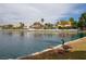 Beautiful lake view with geese by the water, featuring lovely waterfront homes in background at 3125 N Buffalo Dr # 1091, Las Vegas, NV 89128