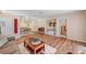 Inviting living room with hardwood floors, cozy seating, and open floor plan to kitchen and hallway at 3125 N Buffalo Dr # 1091, Las Vegas, NV 89128