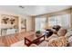 Living room featuring hardwood flooring, a comfortable sofa, natural light and a view to an adjacent bedroom at 3125 N Buffalo Dr # 1091, Las Vegas, NV 89128