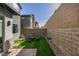 Secluded backyard featuring a brick patio, artificial turf, and a cozy seating area at 3217 Bertonico Ave, Henderson, NV 89044