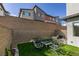 Private backyard with a brick wall, artificial turf, and an inviting seating arrangement at 3217 Bertonico Ave, Henderson, NV 89044