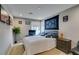 Inviting bedroom with a cozy bed, decorative tapestry, and ample natural light at 3217 Bertonico Ave, Henderson, NV 89044