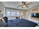 Well-lit bedroom featuring a ceiling fan and a cozy sitting area near window at 3217 Bertonico Ave, Henderson, NV 89044