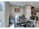 Sunlit breakfast nook features modern table set and seamless connection to the kitchen at 3217 Bertonico Ave, Henderson, NV 89044