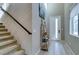 Bright entryway featuring tiled floors, stairs, a modern shelf, and a front door with a large glass panel at 3217 Bertonico Ave, Henderson, NV 89044