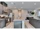 The kitchen features gray cabinets, stainless appliances, granite counters and an open concept layout at 3217 Bertonico Ave, Henderson, NV 89044