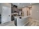 The open concept kitchen boasts granite counters, dark cabinets, and stainless steel appliances at 3217 Bertonico Ave, Henderson, NV 89044