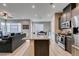 A kitchen with granite counters and stainless appliances opens to a large living area with stylish decor at 3217 Bertonico Ave, Henderson, NV 89044