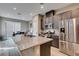 Modern kitchen with stainless steel appliances, granite countertops, and a view into the backyard at 3217 Bertonico Ave, Henderson, NV 89044