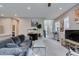 Open living room features neutral paint, plush sofa, modern decor, and views to kitchen at 3217 Bertonico Ave, Henderson, NV 89044