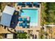 Aerial shot of a community pool area featuring blue umbrellas and lounge chairs at 3217 Bertonico Ave, Henderson, NV 89044