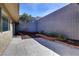 Backyard with concrete tiles, garden, and brick trim at 3371 Royce Ct, Las Vegas, NV 89121