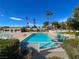 A bright and airy view of the community pool area with palm trees and lounge chairs at 3371 Royce Ct, Las Vegas, NV 89121