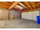 Spacious two-car garage featuring exposed wood beams and concrete block walls at 3371 Royce Ct, Las Vegas, NV 89121