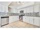 A well-lit kitchen featuring white cabinets, stainless steel appliances, and a modern backsplash at 3371 Royce Ct, Las Vegas, NV 89121