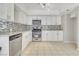 Modern kitchen with white cabinets, stainless steel appliances, and granite countertops at 3371 Royce Ct, Las Vegas, NV 89121