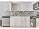 Close-up of a well-equipped kitchen with stainless steel appliances, tile backsplash, and ample cabinetry at 3371 Royce Ct, Las Vegas, NV 89121