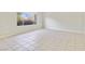 A spacious living room showcasing tile flooring, large windows, and neutral-colored walls at 3371 Royce Ct, Las Vegas, NV 89121