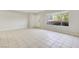 Bright living room featuring tile flooring, a large window and neutral colored walls at 3371 Royce Ct, Las Vegas, NV 89121