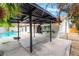 Inviting backyard with a covered patio, bar, and a sparkling pool, ideal for outdoor entertaining at 3409 El Cortez Ave, Las Vegas, NV 89102