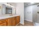 Modern bathroom featuring wood cabinetry, a quartz countertop, sleek fixtures, and a stylish tiled shower at 3409 El Cortez Ave, Las Vegas, NV 89102