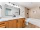 Bathroom featuring modern fixtures, tiled shower, and stylish wood-grain cabinetry at 3409 El Cortez Ave, Las Vegas, NV 89102