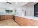 Spacious kitchen featuring quartz countertops, stainless steel appliances, and backyard access at 3409 El Cortez Ave, Las Vegas, NV 89102