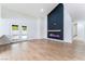 Bright living room features modern fireplace, wood floors, and backyard access at 3409 El Cortez Ave, Las Vegas, NV 89102