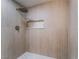 Close-up of a modern shower featuring vertical tile, a rainfall showerhead, and a built-in niche for storage at 3409 El Cortez Ave, Las Vegas, NV 89102