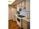 Bright kitchen features wooden cabinets, white appliances, and wood-style flooring at 3550 Bay Sands Dr # 2016, Laughlin, NV 89029