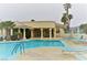 Resort style pool with crystal clear water, lounge chairs, desert landscaping, and a nearby clubhouse at 3550 Bay Sands Dr # 2016, Laughlin, NV 89029