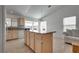 Bright kitchen with island and granite countertops open to dining area and living space at 3750 Horseshoe Mesa St, Las Vegas, NV 89147