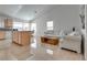 Open-concept living space with tile flooring, a kitchen island, and lots of natural light at 3750 Horseshoe Mesa St, Las Vegas, NV 89147