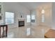 Inviting living room with a fireplace, large windows, and tile flooring at 3750 Horseshoe Mesa St, Las Vegas, NV 89147