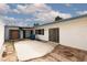 An empty desert landscaped backyard with concrete patio, enclosed by white stucco walls and building at 3871 Sinclair St, Las Vegas, NV 89121