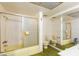 This bathroom features a yellow tub-shower combination, green carpet and a large wall mirror at 3871 Sinclair St, Las Vegas, NV 89121