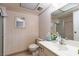 This full bathroom has patterned wallpaper, a vanity, toilet and tub-shower combination at 3871 Sinclair St, Las Vegas, NV 89121