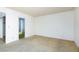 This carpeted bedroom has white walls and an open door to an en-suite bathroom at 3871 Sinclair St, Las Vegas, NV 89121