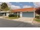 Charming single story home with orange tile roof, blue garage door, and well maintained front yard at 3871 Sinclair St, Las Vegas, NV 89121